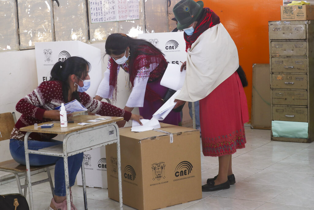 Women vote during general elections in Cangahua, Ecuador, Sunday, Feb. 7, 2021. Amidst the new coronavirus pandemic Ecuadoreans went to the polls in a first round presidential and legislative election. (AP Photo/Dolores Ochoa)