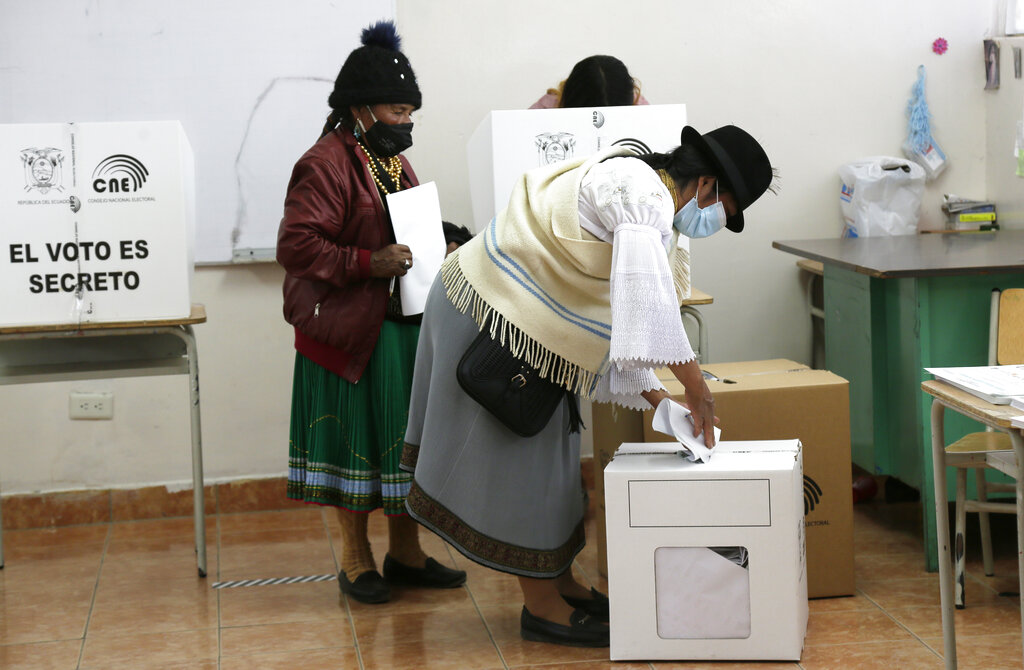 Women cast their ballots in a general election, in Cangahua, Ecuador, Sunday, Feb. 7, 2021. Amidst the new coronavirus pandemic, Ecuadoreans went to the polls in a first-round presidential and legislative election.  (AP Photo/Dolores Ochoa)
