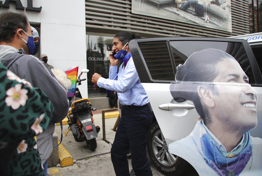 Indigenous rights and environmentalist activist Yaku Perez, who is running for president with the Pachakutik political party, gets out of his car to take a phone call outside the Swissotel where international observers from the previous day's presidential elections are staying in Quito, Ecuador, Monday, Feb. 8, 2021. Perez and his supporters are demanding observers be vigilant of the vote count while it is still undecided who will make it to the second-round vote in April, him or his rival, a conservative former banker Guillermo Lasso, to run against young leftist Andrés Arauz. (AP Photo/Dolores Ochoa)