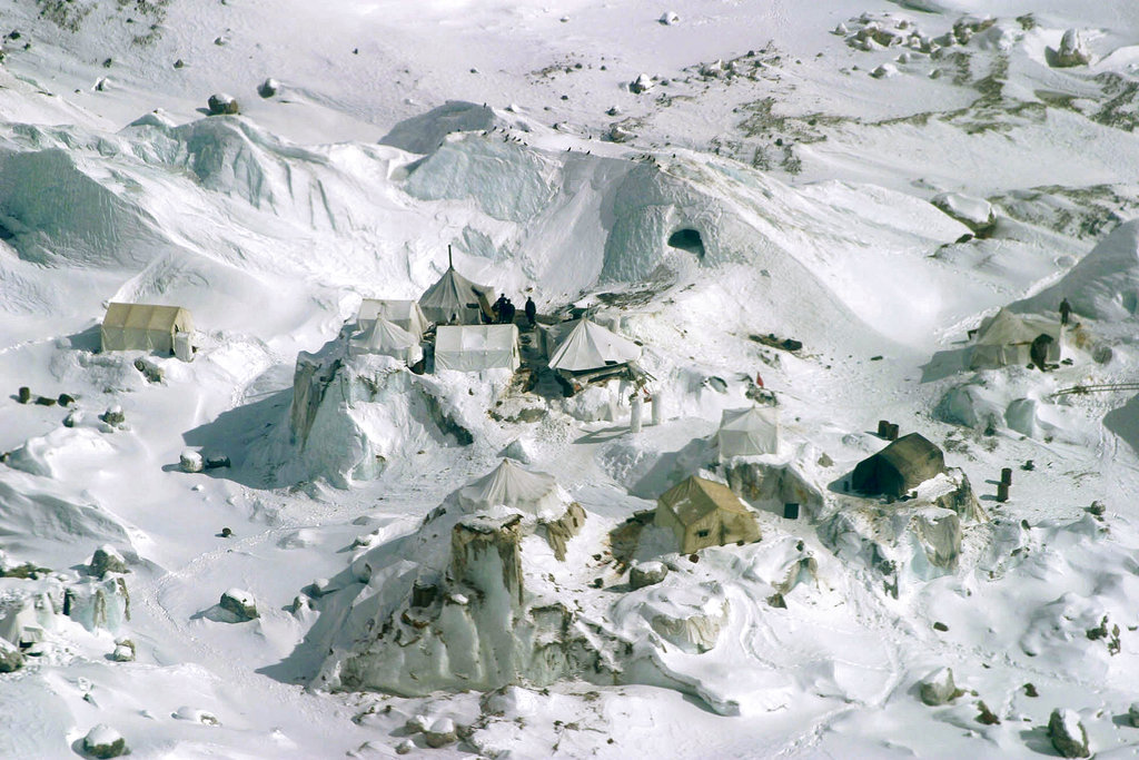 FILE - This Feb. 1, 2005 file photo shows an aerial view of an Indian army camp at Siachen Glacier, about 750 kilometers (469 miles) northwest of Jammu, India.  Siachen Glacier, a 6,100-meter (20,000-foot) icy Himalayan expanse makes up the world's highest battlefield. Thousands of troops have been deployed on the glacier since 1983, laying claim to territory so hostile to human life it has never even been demarcated. Far more troops have died from avalanches or bitter cold than in combat. While there are no clear borders on the glacier, its position between the Indian and Pakistani-controlled portions of Kashmir make it a key part of any final map that may be drawn of the region. Its high altitude gives its occupants an advantage over those below. (AP Photo/Channi Anand, File)