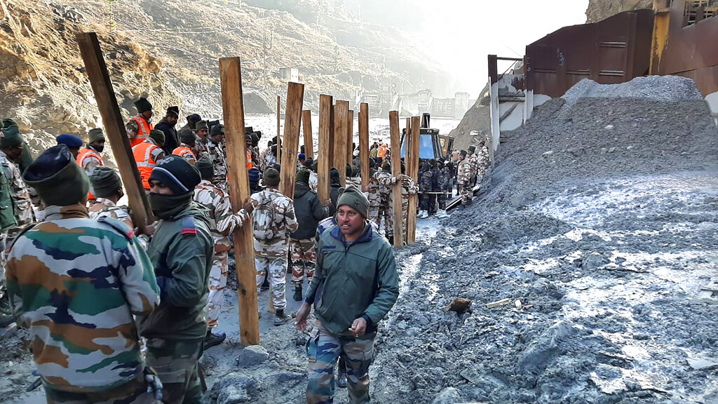 Indo Tibetan Border Police (ITBP) personnel undertake rescue work at one of the hydro power project at Reni village in ​​Chamoli district, in Indian state of Uttrakhund, Monday, Feb.8, 2021. Rescue efforts continued on Monday to save 37 people after part of a glacier broke off, releasing a torrent of water and debris that slammed into two hydroelectric plants on Sunday. (AP Photo)