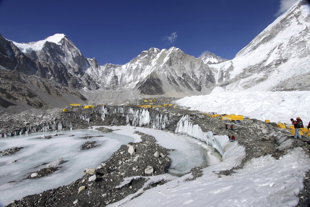 FILE - In this April 11, 2015 file photo, tents are seen set up for climbers on the Khumbu Glacier, with Mount Khumbutse, center, and Khumbu Icefall, right, seen in background, at Everest Base Camp in Nepal. The floods that slammed into two hydroelectric plants and damaged villages in northern India were set off by a break on a Himalayan glacier upstream. Glaciers advance and retreat with cycles of snowfall and melting, and can form glacial lakes behind them. This pattern builds up water, as well as a risk the water will break free and flood areas downstream. (AP Photo/Tashi Sherpa, File)