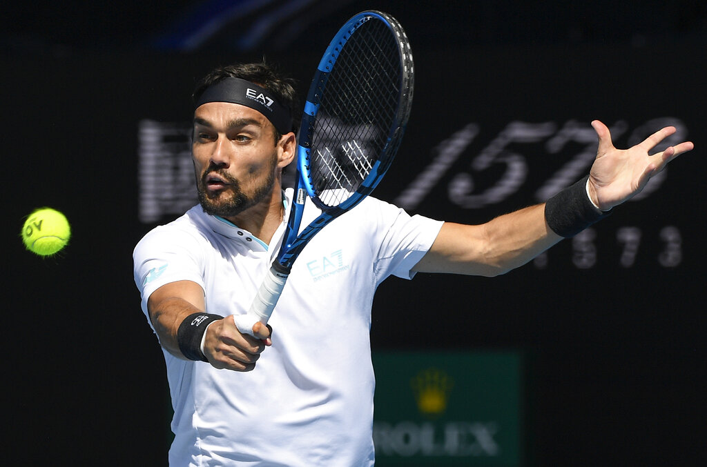 Italy's Fabio Fognini hits a backhand return to Spain's Rafael Nadal during their fourth round match at the Australian Open tennis championship in Melbourne, Australia, Monday, Feb. 15, 2021.(AP Photo/Andy Brownbill)