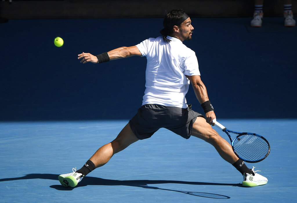 Italy's Fabio Fognini hits a backhand return to Spain's Rafael Nadal during their fourth round match at the Australian Open tennis championship in Melbourne, Australia, Monday, Feb. 15, 2021.(AP Photo/Andy Brownbill)