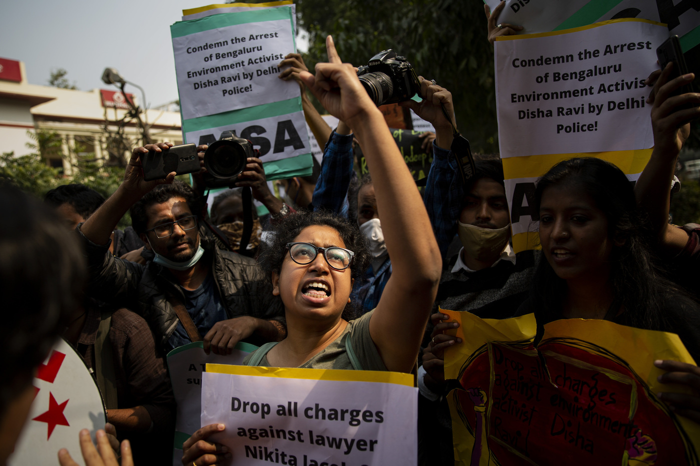 Indian students hold placards and shout slogans condemning police action against various activists during a protest in New Delhi, India, Tuesday, Feb. 16, 2021. Police on Saturday arrested climate activist Disha Ravi, for circulating a document on social media supporting months of massive protests by farmers. Police also issued arrest warrants for two other activists, Nikita Jacob and Shantanu Muluk, saying the three created the document and shared it with others. According to police, the sharing of the document on social media indicated there was a “conspiracy” behind violence on Jan. 26, India's Republic Day, when the largely peaceful farmer protests erupted into clashes with police. (AP Photo/Altaf Qadri)