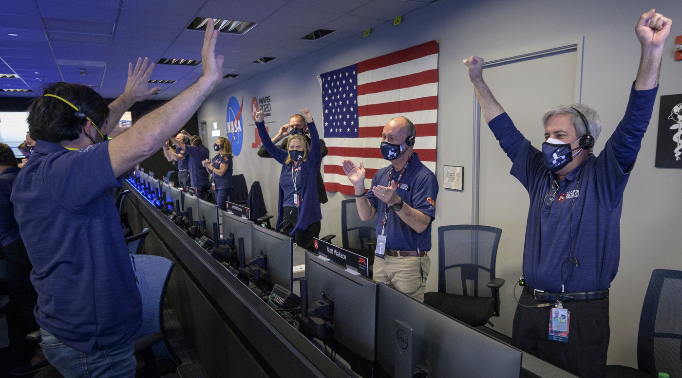In this photo provided by NASA, members of NASA's Perseverance rover team react in mission control after receiving confirmation the spacecraft successfully touched down on Mars, Thursday, Feb. 18, 2021, at NASA's Jet Propulsion Laboratory in Pasadena, Calif. The landing of the six-wheeled vehicle marks the third visit to Mars in just over a week. Two spacecraft from the United Arab Emirates and China swung into orbit around the planet on successive days last week. (Bill Ingalls/NASA via AP)
