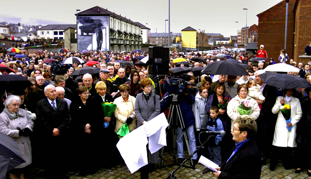 Hundreds of people stand still in silence to remember all those killed exactly thirty years ago by British Paratroopers in hotly disputed circumstances, in the Bogside area of Londonderry, northern Ireland, Wednesday, Jan. 30, 2002. (AP Photo/Peter Morrison)
