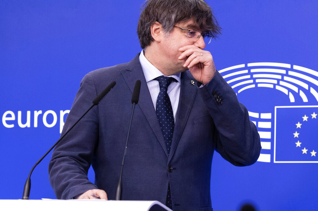 FILE - In this Wednesday, Feb. 24, 2021 file photo, former Catalan leader Carles Puigdemont speaks during a media conference at the European Parliament in Brussels. A key European Parliament committee voted Tuesday to lift the immunity of three former top Catalan officials who fled Spain fearing arrest over a secessionist push they led in the region, possibly paving the way for their extradition. (AP Photo/Olivier Matthys, File)