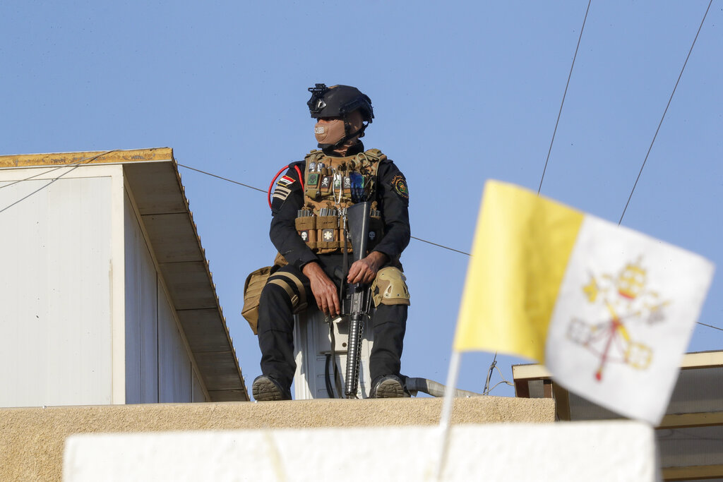 Iraqi security forces patrol near the Chaldean Cathedral of Saint Joseph where Pope Francis is expected to concelebrate mass in, in Baghdad, Iraq, Saturday, March 6, 2021. Earlier today Francis met privately with the country's revered Shiite leader, Grand Ayatollah Ali al-Sistani. (AP Photo/Andrew Medichini)