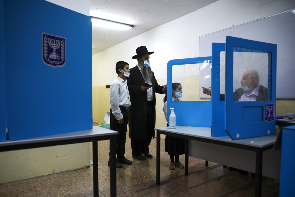 Ultra-Orthodox Jewish man arrives to vote for Israel's parliamentary election at a polling station in Bnei Brak, Israel, Tuesday, March. 23, 2021. Israel is holding its fourth election in less than two years. (AP Photo/Oded Balilty)