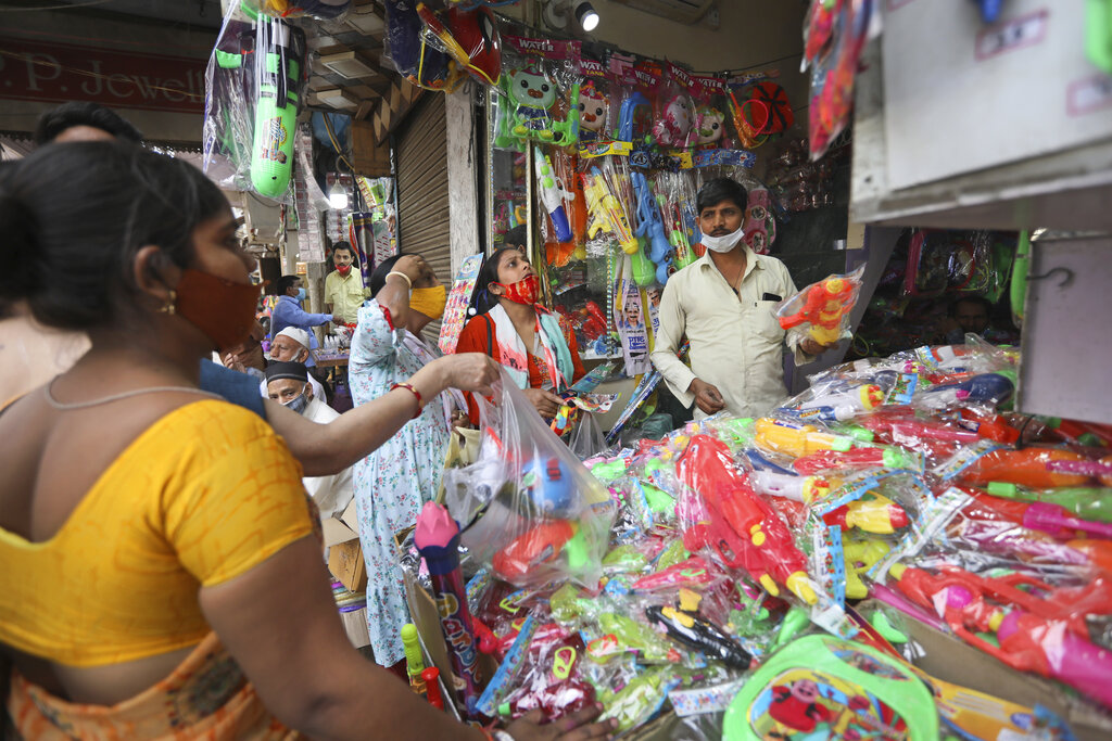 People shop for water pistols ahead of Holi, the Hindu festival of colors, in New Delhi, India, Thursday, March 25, 2021. (AP Photo/Manish Swarup)