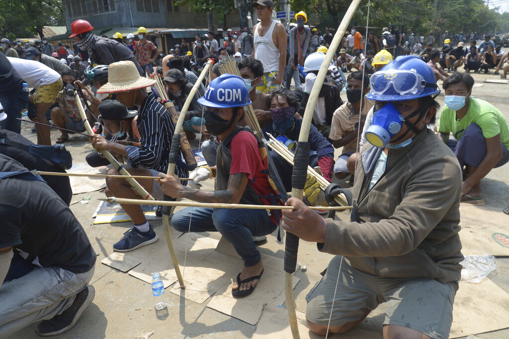 Anti-coup protesters prepare makeshift bow and arrows to confront police in Thaketa township Yangon, Myanmar, Saturday, March 27, 2021. The head of Myanmar’s junta on Saturday used the occasion of the country’s Armed Forces Day to try to justify the overthrow of the elected government of Aung San Suu Kyi, as protesters marked the holiday by calling for even bigger demonstrations. (AP Photo)