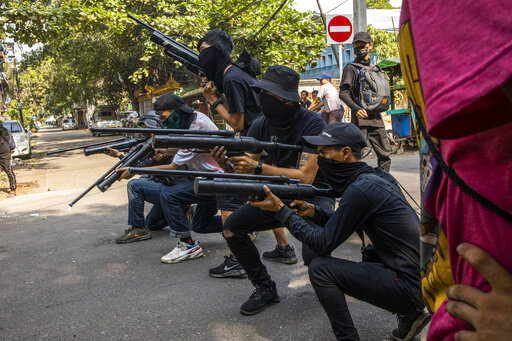 Anti-coup protesters line in formation with homemade air rifles during a demonstration against the military coup in Yangon, Myanmar, Saturday, April 3, 2021. Threats of lethal violence and arrests of protesters have failed to suppress daily demonstrations across Myanmar demanding the military step down and reinstate the democratically elected government. (AP Photo)
