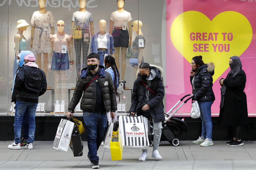 People queue to get into Primark store on Oxford Street in London, Monday, April 12, 2021. Millions of people in England will get their first chance in months for haircuts, casual shopping and restaurant meals on Monday, as the government takes the next step on its lockdown-lifting road map. (AP Photo/Kirsty Wigglesworth)