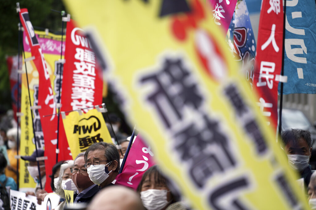 People chant slogans against government's decision to start releasing massive amounts of treated radioactive water from the wrecked Fukushima nuclear plant into the sea, during a rally outside the prime minister's office in Tokyo Tuesday, April 13, 2021. The decision, long speculated but delayed for years due to safety concerns and protests, came at a meeting of Cabinet ministers who endorsed the ocean release as the best option. (AP Photo/Eugene Hoshiko)