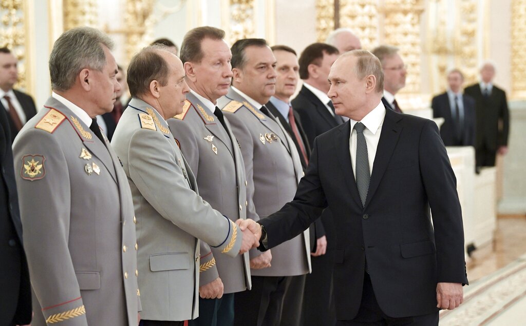 Russian President Vladimir Putin, right, shakes hands with Alexander Bortnikov, head of the Federal Security Service (FSB), second left, as he arrives to attend a meeting with top military and law enforcement officials in the Kremlin in Moscow, Russia, Thursday, April 11, 2019. (Alexei Nikolsky, Sputnik, Kremlin Pool Photo via AP)