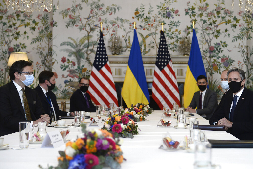 Ukrainian Foreign Minister Dmytro Kuleba, left, meets with United States Secretary of State Antony Blinken, right, in Brussels, Tuesday, April 13, 2021. (Johanna Geron, Pool via AP)