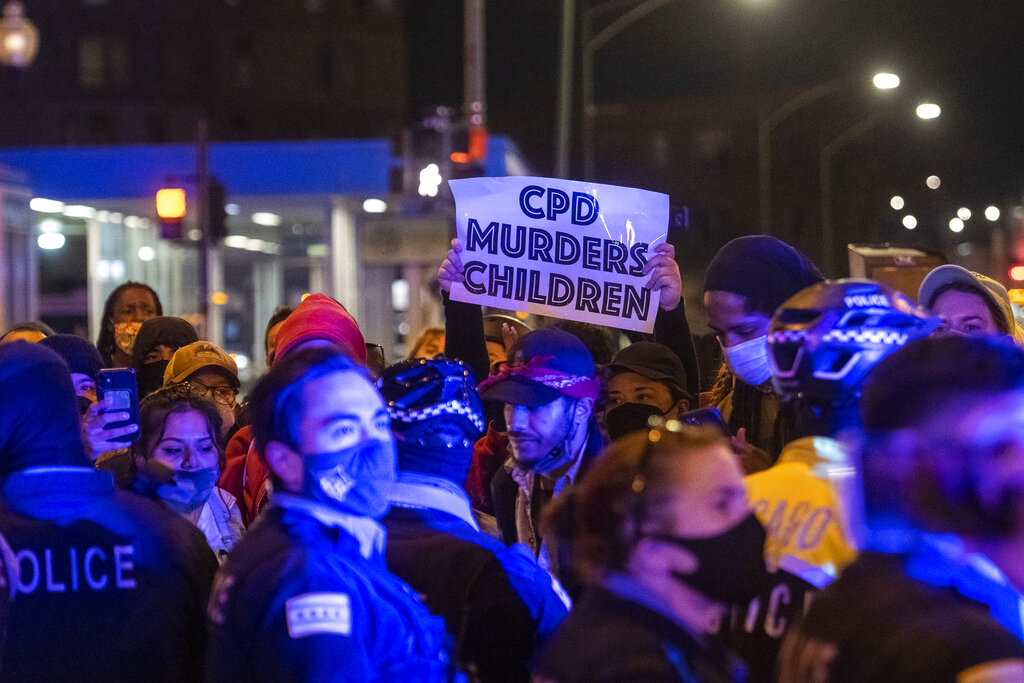Chicago police and protester square off after an earlier clash near Logan Square Park in Chicago, after a peaceful march through the Logan Square neighborhood in response to the Chicago police fatal shooting of Adam Toledo in late March, Friday, April 16, 2021. (Tyler LaRiviere/Chicago Sun-Times via AP)