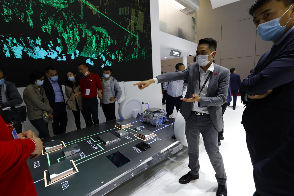 A worker introduces the Huawei Intelligent Car Solution displayed during the Shanghai Auto Show in Shanghai on Monday, April 19, 2021. Automakers are looking to China, their biggest market by sales volume and the first major economy to rebound from the pandemic, to revive sales and reverse multibillion-dollar losses. (AP Photo/Ng Han Guan)