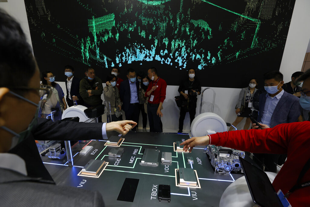 Visitors look at the Huawei Intelligent Car Solution displayed during the Shanghai Auto Show in Shanghai on Monday, April 19, 2021. Automakers are looking to China, their biggest market by sales volume and the first major economy to rebound from the pandemic, to revive sales and reverse multibillion-dollar losses. (AP Photo/Ng Han Guan)