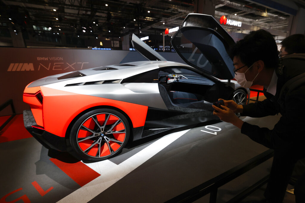 A visitor looks at the BMW Vision Next concept car displayed during the Shanghai Auto Show in Shanghai on Monday, April 19, 2021. Automakers are looking to China, their biggest market by sales volume and the first major economy to rebound from the pandemic, to revive sales and reverse multibillion-dollar losses. (AP Photo/Ng Han Guan)