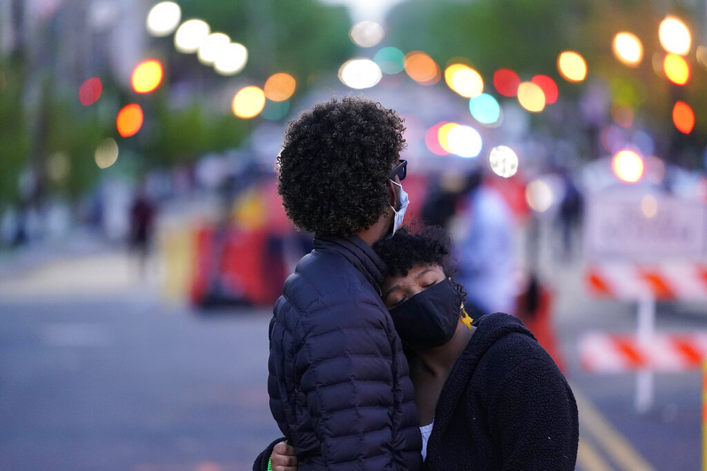 A couple dances at Black Lives Matter Plaza near the White House on Tuesday, April 20, 2021, in Washington, after the verdict in Minneapolis, in the murder trial against former Minneapolis police officer Derek Chauvin was announced. (AP Photo/Alex Brandon)