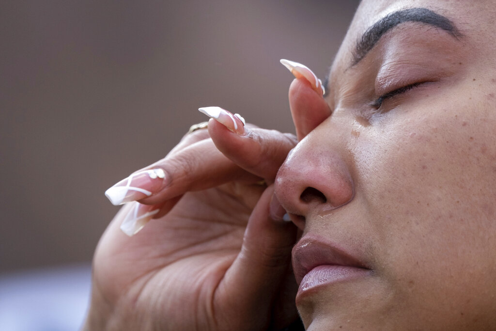 Qri Montague wipes away a tear during a gathering and march in Atlanta after Derek Chauvin was found guilty of three counts in the death of George Floyd, Tuesday, April 20, 2021. (AP Photo/Ben Gray)