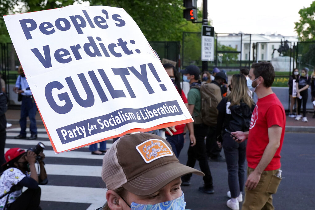People react on Tuesday, April 20, 2021, in Washington, at Black Lives Matter Plaza near the White House after the verdict in Minneapolis, in the murder trial against former Minneapolis police officer Derek Chauvin was announced. (AP Photo/Jacquelyn Martin)