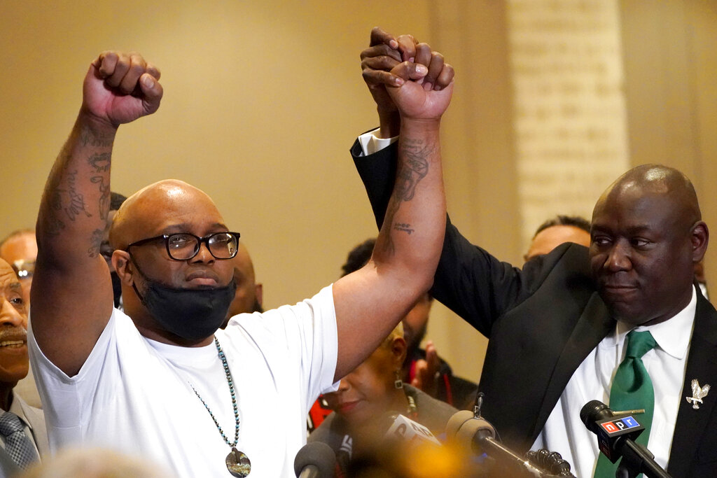 Terrence Floyd, brother of George Floyd, holds his hands up with the help of Ben Crump, attorney representing George Floyd's family, during a news conference after the verdict was read in the trial of former Minneapolis Police officer Derek Chauvin, Tuesday, April 20, 2021, in Minneapolis. (AP Photo/Julio Cortez)