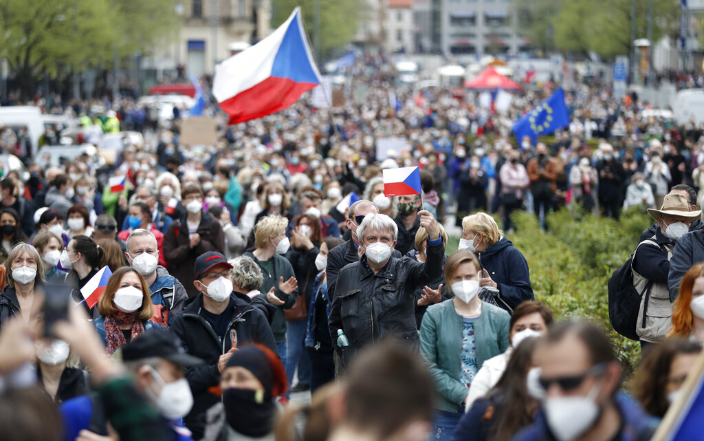 People attend a demonstration in Prague, Czech Republic, Thursday, April 29, 2021. Thousands of Czechs have rallied in the capital against President Milos Zeman, accusing him of treason for his pro-Russian stance over the alleged participance of Russian spies in a Czech huge ammunition explosion. (AP Photo/Petr David Josek)