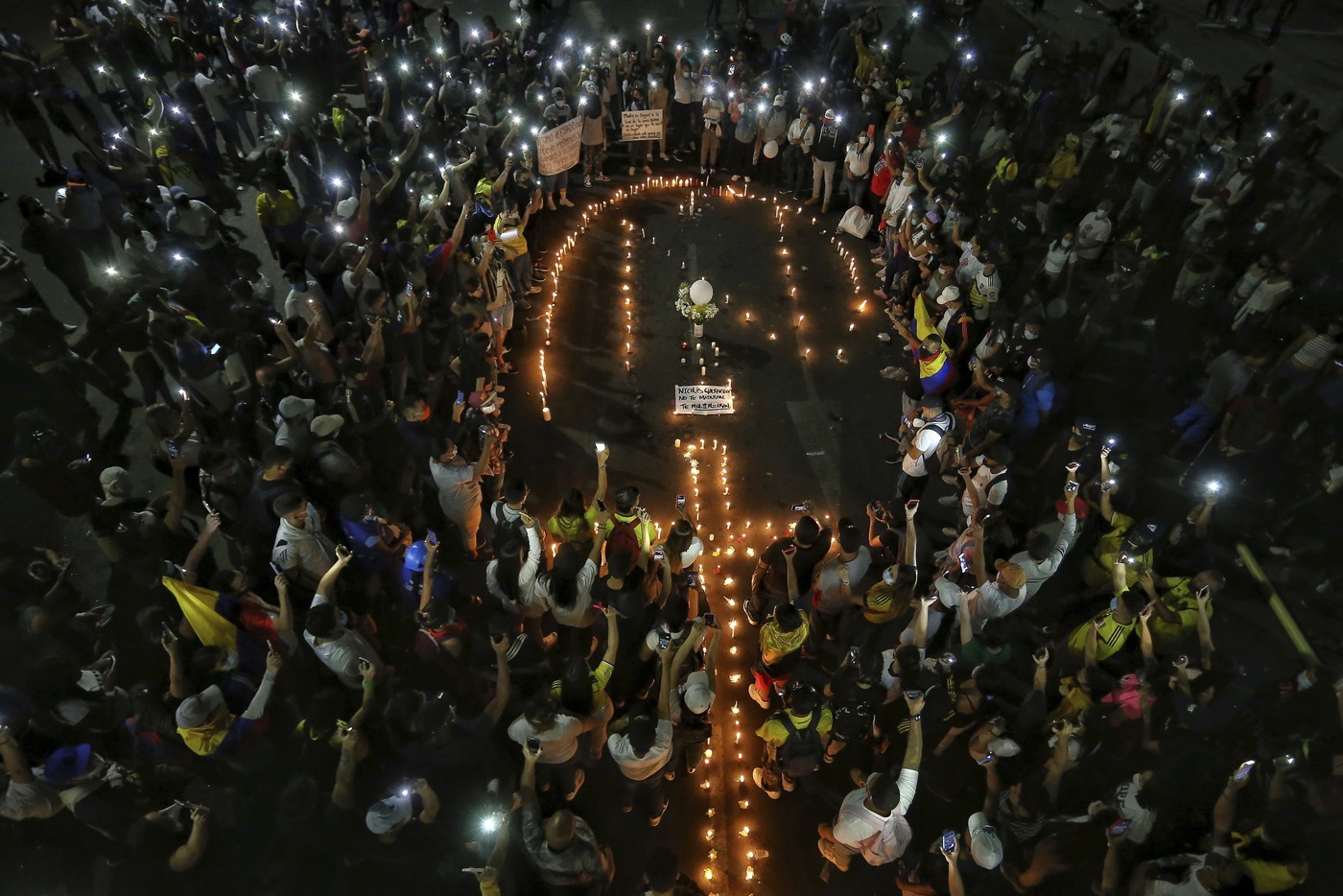 People light candles during a vigil in honor of Nicolas Guerrero who died after being shot during a national strike against tax reform in Cali, Colombia, Monday, May 3, 2021. Guerrero was shot during clashes with police on Sunday and died this morning. Colombia’s President Ivan Duque withdrew the government-proposed tax reform on Sunday. (AP Photo/Andres Gonzalez)
