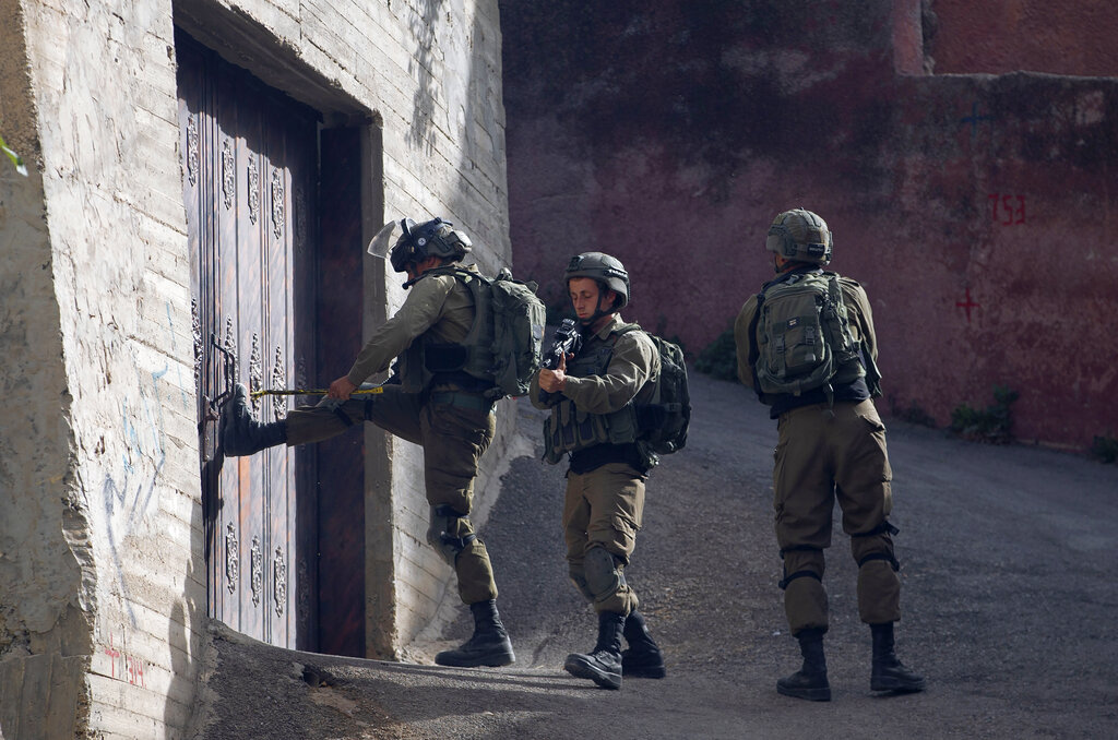 Israeli troops deploy during an army operation to search for a suspected Palestinian gunmen in the village of Aqraba, near the West Bank town of Nablus, Tuesday, May 4, 2021. On Sunday gunmen in a passing car opened fire at Israelis standing at a major intersection in the Israeli-occupied West Bank on Sunday, injuring three of them, according to rescue officials and the military. (AP Photo/Majdi Mohammed)