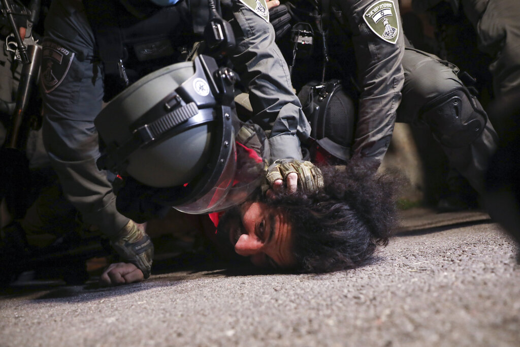 Israeli police officers detain a Palestinian demonstrator during a protest against the planned evictions of Palestinian families in the Sheikh Jarrah neighborhood of east Jerusalem, Tuesday, May 4, 2021. (AP Photo/Mahmoud Illean)