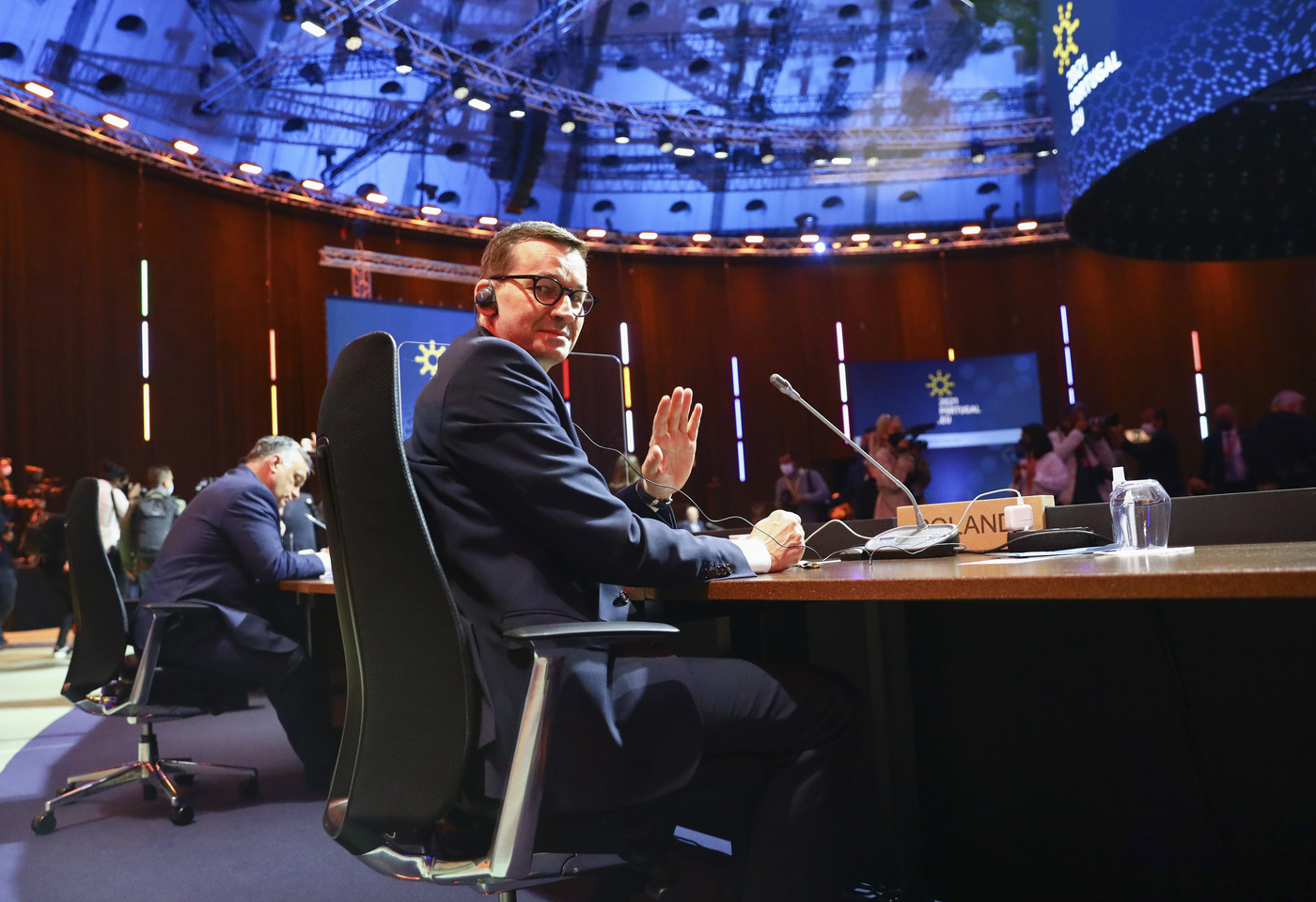 Poland's Prime Minister Mateusz Morawiecki waves during an EU summit round table meeting at the Crystal Palace in Porto, Portugal, Saturday, May 8, 2021. On Saturday, EU leaders hold an online summit with India's Prime Minister Narendra Modi, covering trade, climate change and help with India's COVID-19 surge. (Violeta Santos Moura, Pool via AP)