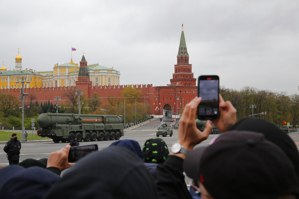 People watch and photograph as a Russian RS-24 Yars ballistic missile rolls past the Kremlin after the Victory Day military parade in Moscow, Russia, Sunday, May 9, 2021, marking the 76th anniversary of the end of World War II in Europe. Russian President Vladimir Putin marked the anniversary of the end of World War II in Europe with a speech warning that Nazi beliefs remain strong. (AP Photo/Alexander Zemlianichenko Jr.)