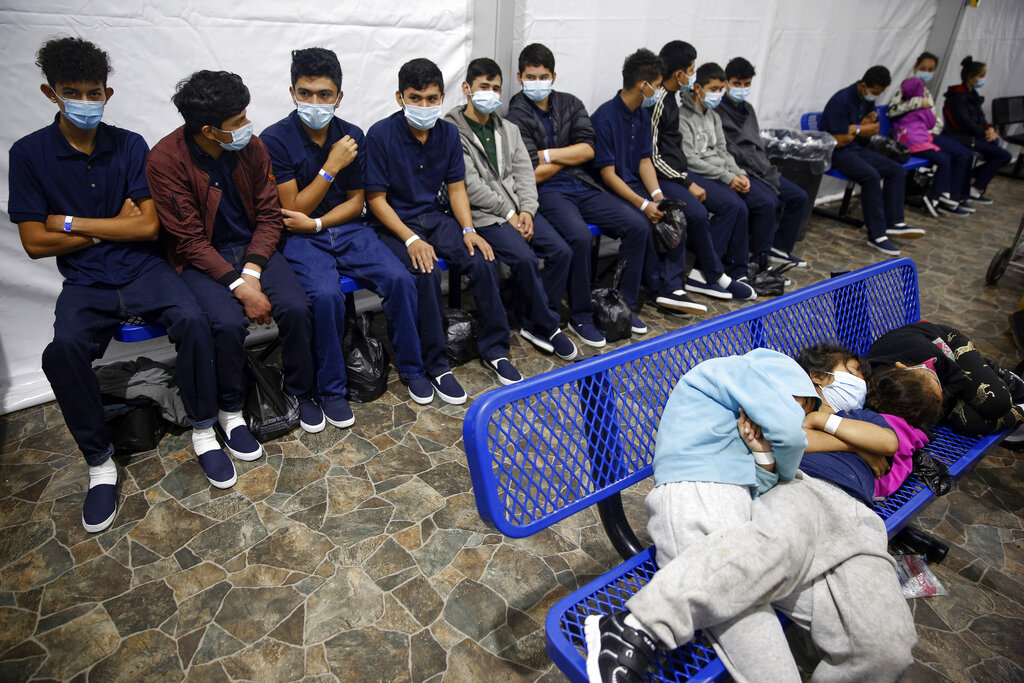 FILE - In this March 30, 2021, file photo, young unaccompanied migrants wait for their turn at the secondary processing station inside the U.S. Customs and Border Protection facility, the main detention center for unaccompanied children in the Rio Grande Valley, in Donna, Texas. The number of unaccompanied children encountered on the U.S. border with Mexico in April 2021 eased from an all-time high a month earlier, while more adults are coming without families. Authorities encountered nearly 17,200 children traveling alone, down 9% from March but still far above the previous high in May 2019. (AP Photo/Dario Lopez-Mills, Pool, File)