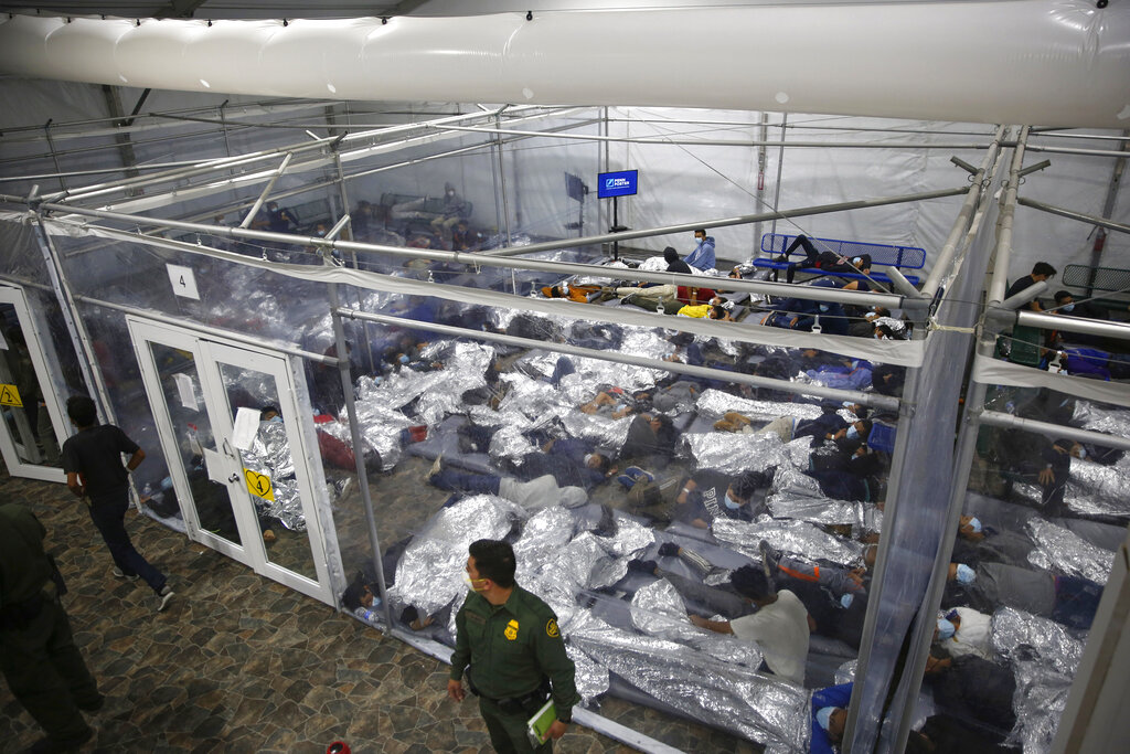 FILE - In this March 30, 2021, file photo, young minors lie inside a pod at the Donna Department of Homeland Security holding facility, the main detention center for unaccompanied children in the Rio Grande Valley run by U.S. Customs and Border Protection (CBP), in Donna, Texas. The number of unaccompanied children encountered on the U.S. border with Mexico in April 2021 eased from an all-time high a month earlier, while more adults are coming without families. Authorities encountered nearly 17,200 children traveling alone, down 9% from March but still far above the previous high in May 2019. (AP Photo/Dario Lopez-Mills, Pool, File)