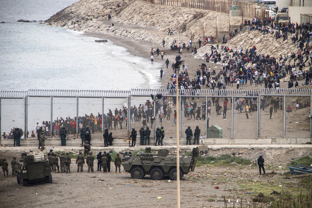 Spanish Army take positions at the border of Morocco and Spain, at the Spanish enclave of Ceuta, on Tuesday, May 18, 2021. Ceuta, a Spanish city of 85,000 in northern Africa, faces a humanitarian crisis after thousands of Moroccans took advantage of relaxed border control in their country to swim or paddle in inflatable boats into European soil. Around 6,000 people had crossed by Tuesday morning since the first arrivals began in the early hours of Monday, including 1,500 who are presumed to be teenagers. (AP Photo/Javier Fergo)