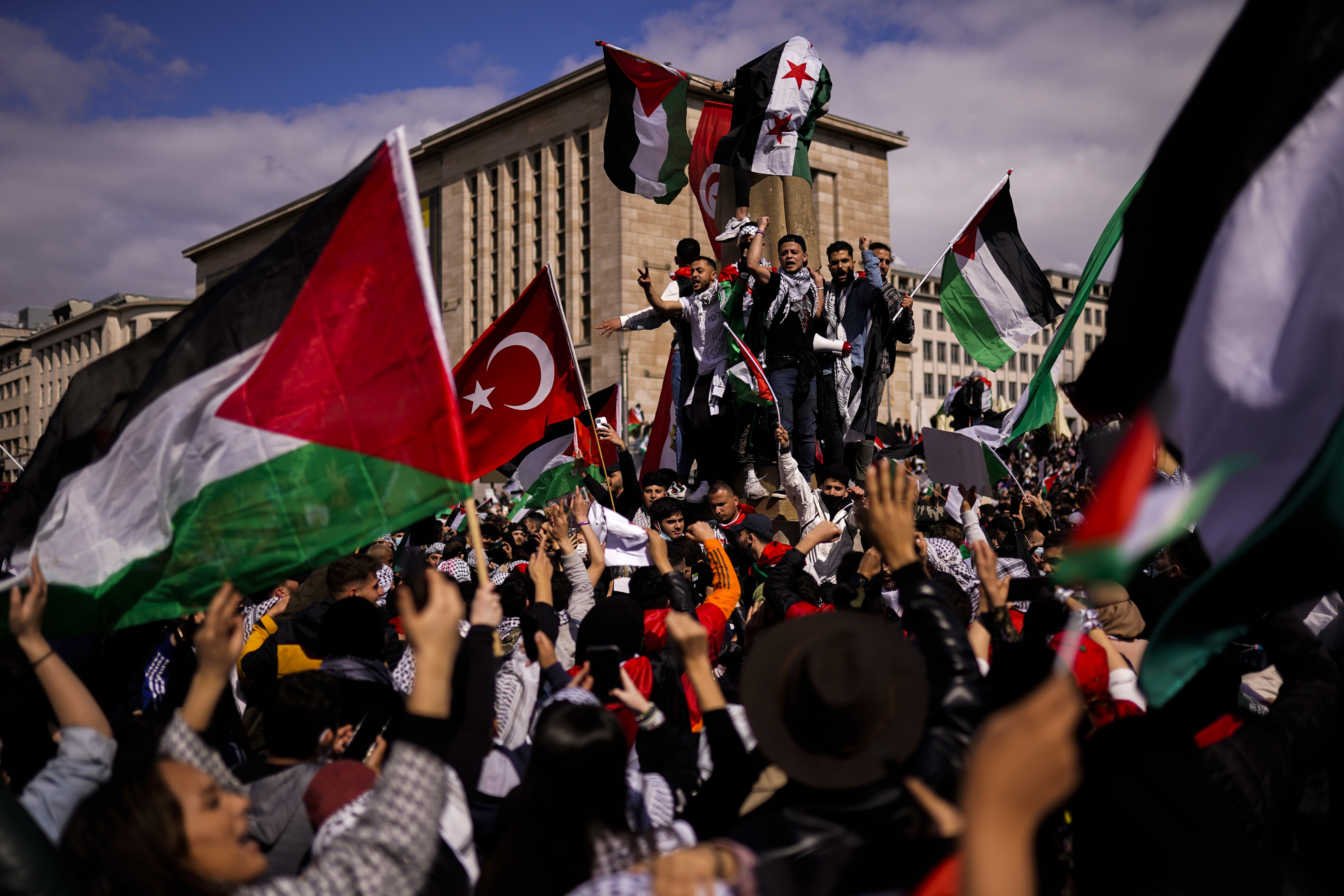 People wave Palestinian and a Turkish flag as they shout slogans during a protest in support of Palestinians in the Gaza Strip, in Brussels, Saturday, May 15, 2021. (AP Photo/Francisco Seco)