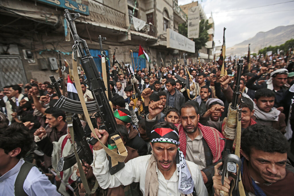 Houthi supporters hold weapons as they chant slogans during a protest against Israeli attacks on Palestinians in Gaza, in Sanaa, Yemen, Monday, May 17, 2021. (AP Photo/Hani Mohammed)