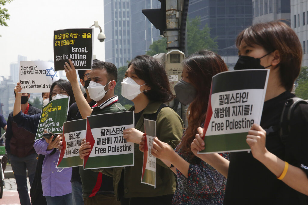 Palestinian people and South Korean activists stage a protest against Israeli attacks on Gaza, in front of Israeli Embassy in Seoul, South Korea, Tuesday, May 18, 2021. (AP Photo/Ahn Young-joon)