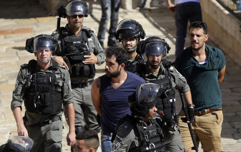 Israeli police arrests a Palestinian during clashes between Israeli security forces and Palestinian protesters in Jerusalem's Old City, Tuesday, May 18, 2021. (AP Photo/Mahmoud Illean)