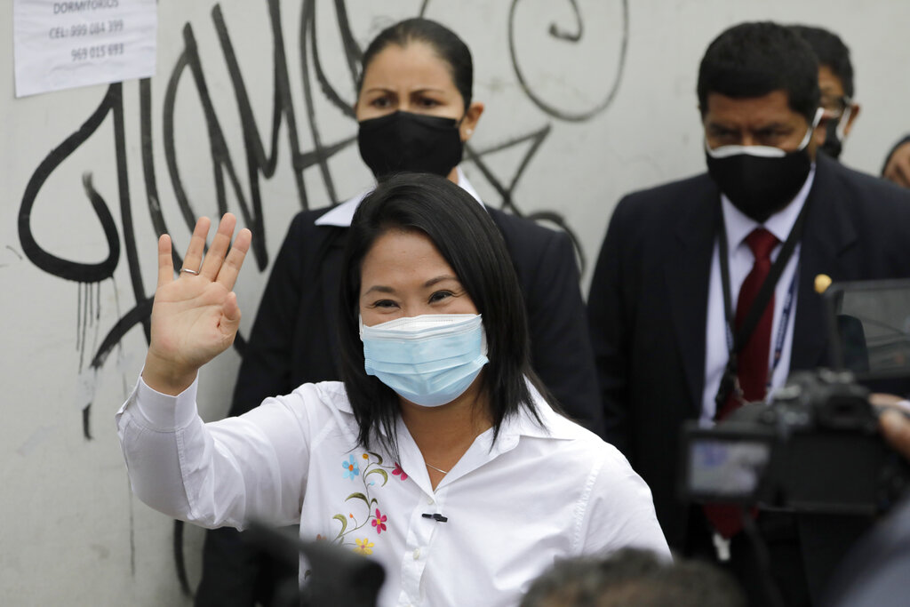 Presidential candidate Keiko Fujimori waves at supporters after casting her vote in Lima, Peru, Sunday, June 6, 2021. Peruvians head to the polls in a presidential run-off election to choose between Fujimori, the daughter of jailed ex-President Alberto Fujimori, and political novice Pedro Castillo. (AP Photo/Guadalupe Pardo)