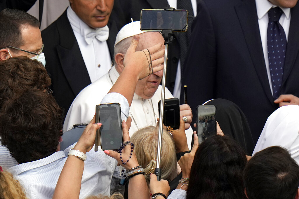 A faithful reaches out towards Pope Francis as he arrives for his weekly general audience, at the Vatican, Wednesday, June 9, 2021. (AP Photo/Alessandra Tarantino)