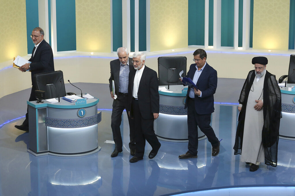 FILE - In this Saturday, June 12, 2021 file photo made available by Young Journalists Club, YJC, presidential candidates for June 18, elections Alireza Zakani, left, Mohsen Mehralizadeh, second left, Saeed Jalili, center, Abdolnasser Hemmati, second right, and Ebrahim Raisi leave at the conclusion of a part of the final debate of the candidates at a state-run TV studio in Tehran, Iran. The presidential election is likely to be a coronation for Raisi, a hard-line candidate long cultivated by Supreme Leader Ayatollah Ali Khamenei. (Morteza Fakhri Nezhad/ Young Journalists Club, YJC via AP, File)