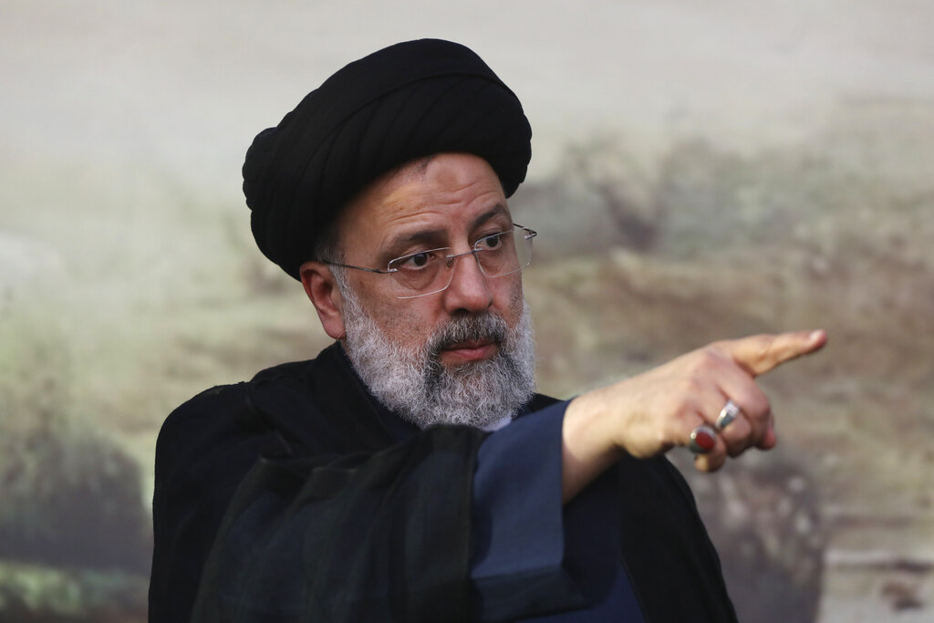 FILE - In this June 6, 2021 file photo, Presidential candidate Ebrahim Raisi, points during a campaign rally in Eslamshahr, southwest of Tehran, Iran. The presidential election on Friday, June 18, is likely to be a coronation for Raisi, a hard-line candidate long cultivated by Supreme Leader Ayatollah Ali Khamenei. (AP Photo/Vahid Salemi, File)