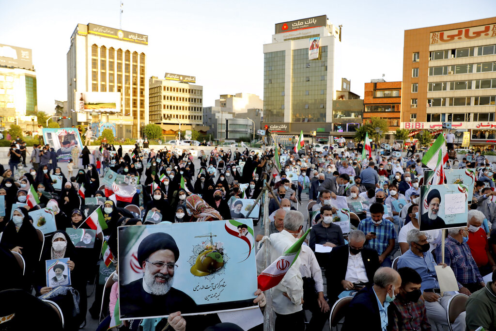 Supporters of presidential candidate Ebrahim Raisi, shown in posters, attend a rally in Tehran, Iran, Monday, June 14, 2021. Iran's clerical vetting committee has allowed just seven candidates for the Friday, June 18, ballot, nixing prominent reformists and key allies of President Hassan Rouhani. The presumed front-runner has become Ebrahim Raisi, the country's hard-line judiciary chief who is closely aligned with Supreme Leader Ayatollah Ali Khamenei. (AP Photo/Ebrahim Noroozi)
