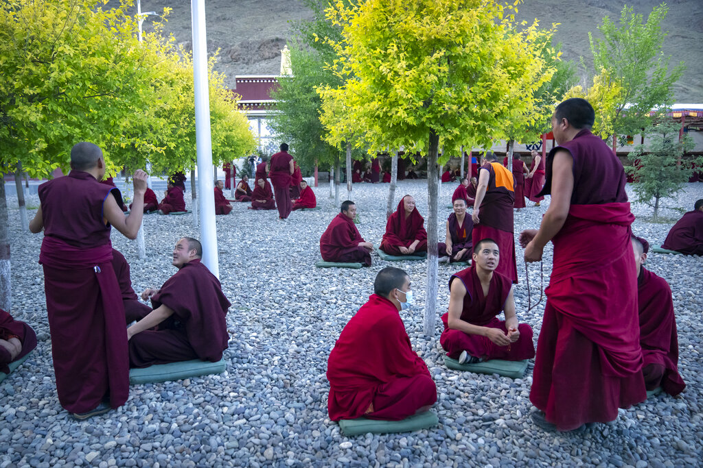 Monks engage in debate in an outdoor area at the Tibetan Buddhist College near Lhasa in western China's Tibet Autonomous Region, Monday, May 31, 2021, as seen during a government organized visit for foreign journalists. High-pressure tactics employed by China's ruling Communist Party appear to be finding success in separating Tibetans from their traditional Buddhist culture and the influence of the Dalai Lama. (AP Photo/Mark Schiefelbein)