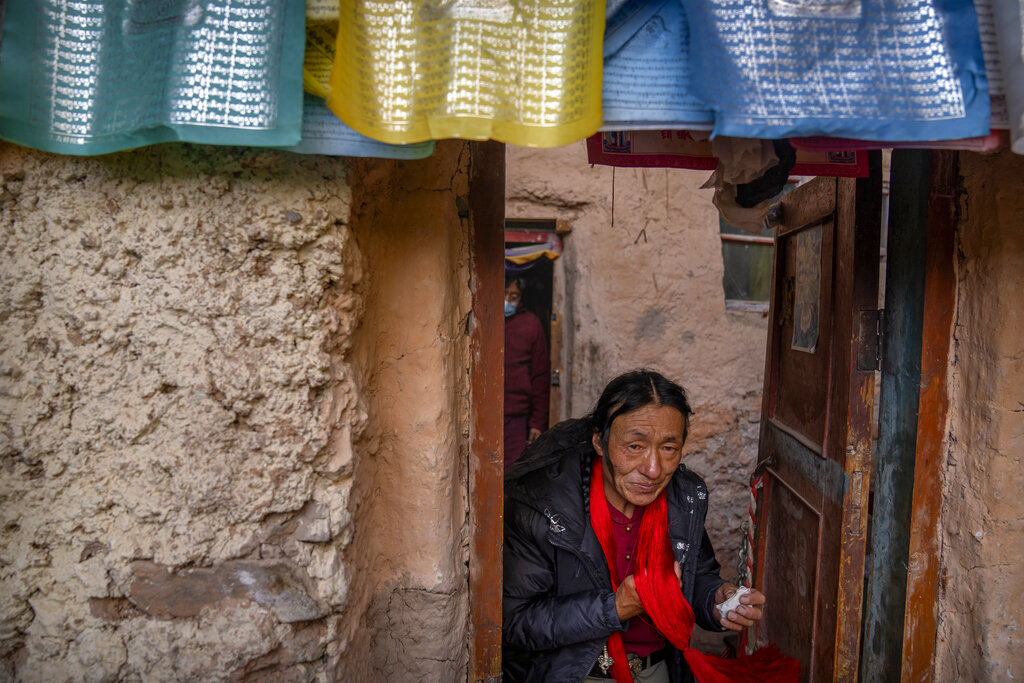 A Tibetan man leaves a Buddhist holy site built in a grotto in Namtso in western China's Tibet Autonomous Region, Wednesday, June 2, 2021, as seen during a government organized visit for foreign journalists. High-pressure tactics employed by China's ruling Communist Party appear to be finding success in separating Tibetans from their traditional Buddhist culture and the influence of the Dalai Lama. (AP Photo/Mark Schiefelbein)