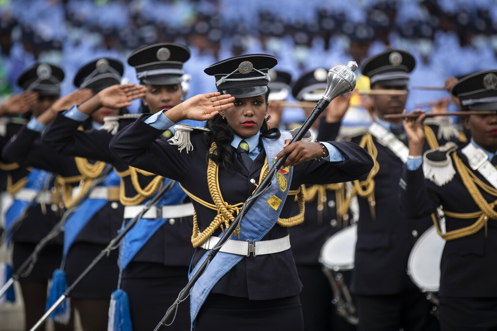 Members of an Ethiopian police marching band salute during the national anthem at a parade to display new police uniforms and instruct them to maintain impartiality and respect the law during the upcoming election, in Meskel Square in downtown Addis Ababa, Ethiopia Saturday, June 19, 2021. The country is due to vote in a general election on Monday, June, 21, 2021, the centerpiece of a reform drive by Prime Minister Abiy Ahmed. (AP Photo/Ben Curtis)
